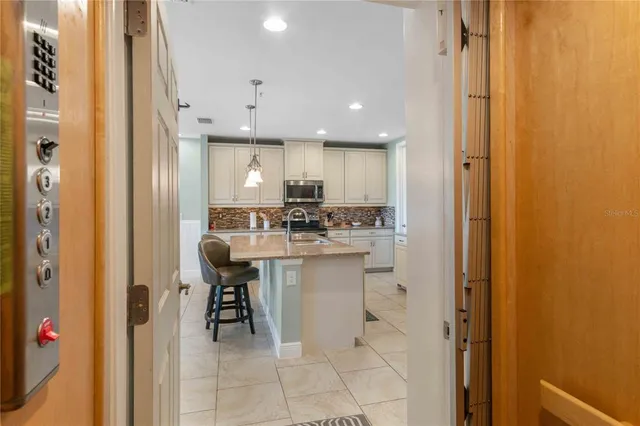 a living room with furniture and kitchen view