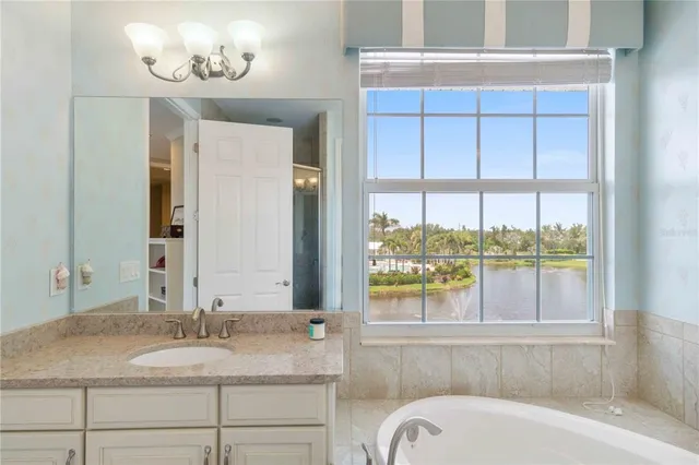 a bathroom with a granite countertop sink a toilet and shower