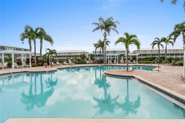 a view of a patio with couches table and chairs and potted plants