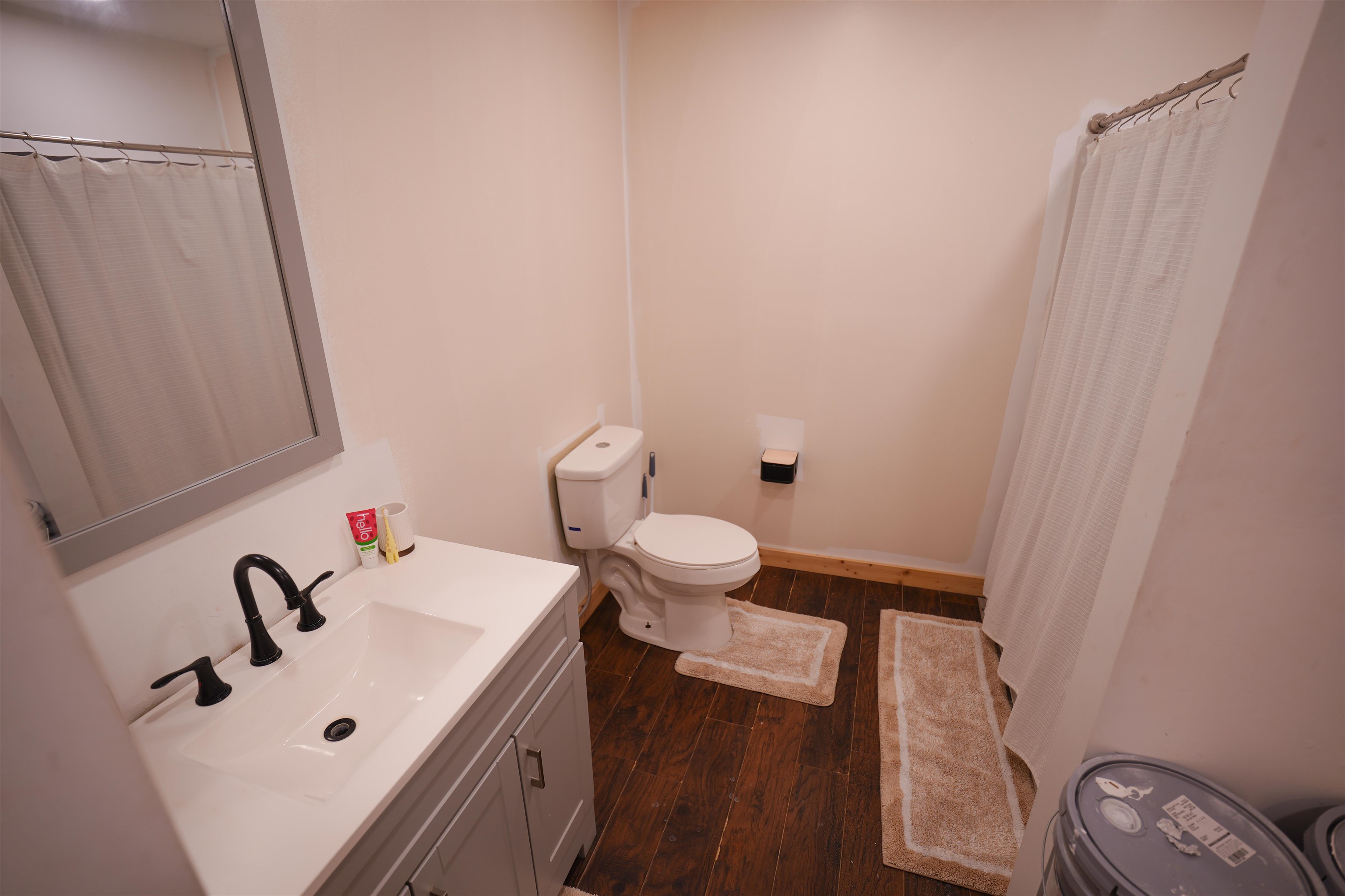 2525 Pittman Road Somerville, TN 38068 - Photo 11 of 38 Vanity with white countertop and integrated sink, matte black faucet, and gray-framed mirror