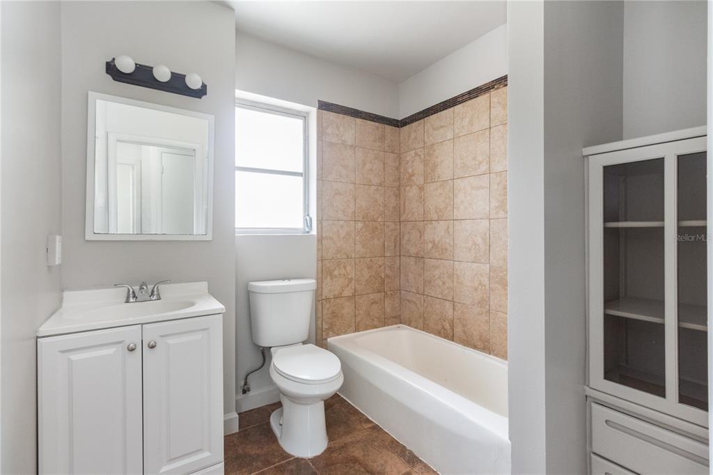 7208 Fair Oaks Street Spring Hill, FL 34606 - Photo 12 of 25 a white toilet sitting next to a bathroom sink
