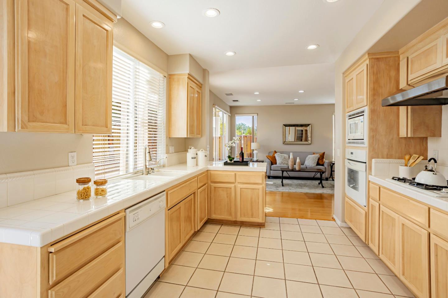 964 Cameron Circle Milpitas, CA 95035 - Photo 13 of 48 a kitchen with a sink a stove and cabinets