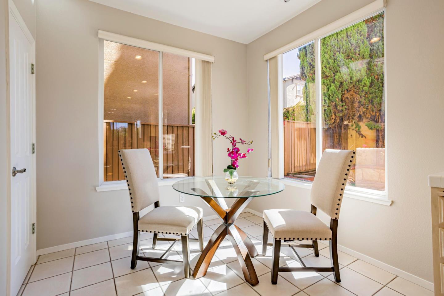 964 Cameron Circle Milpitas, CA 95035 - Photo 16 of 48 a view of a dining room with furniture large windows and wooden floor