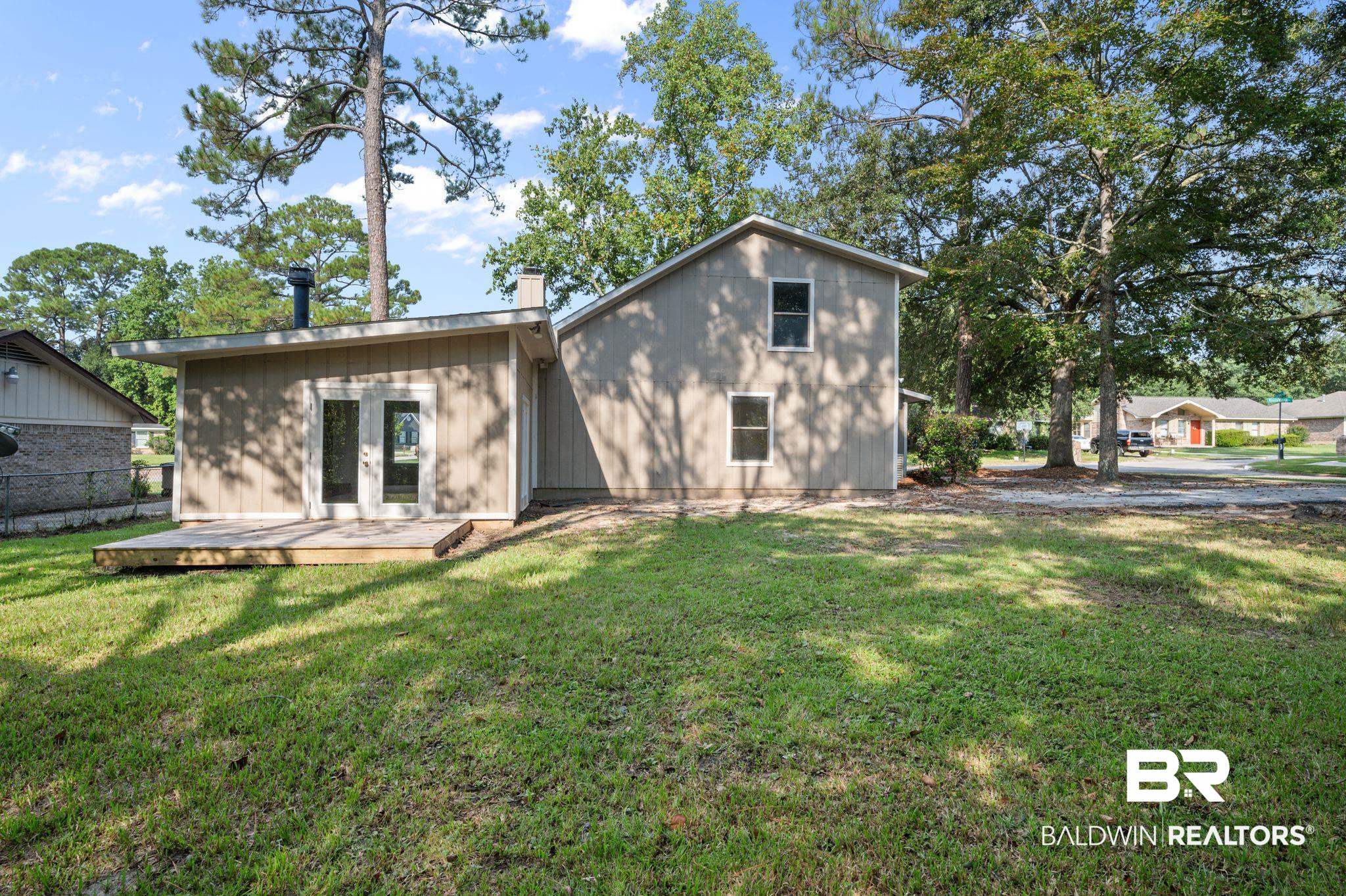 3701 Vista Ridge Drive Mobile, AL 36693 - Photo 5 of 33 Back of property featuring a lawn and a wooden deck