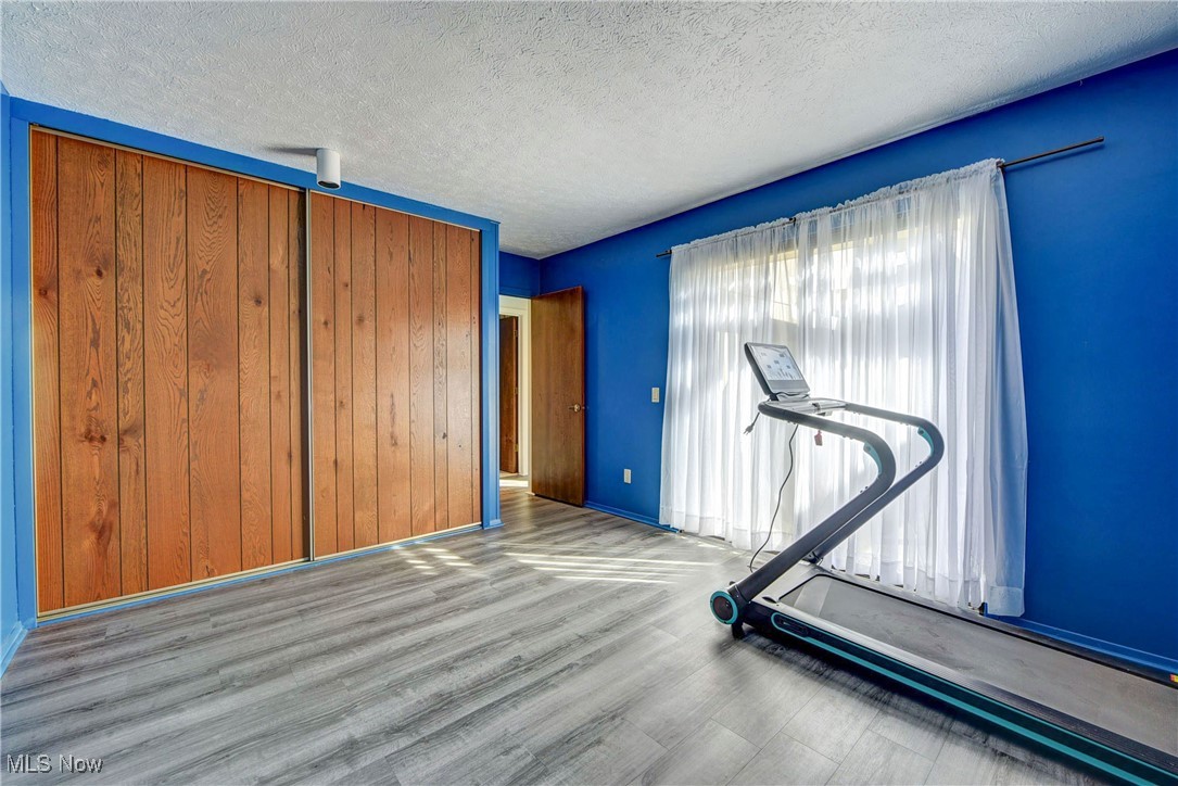 10810 Priem Road Strongsville, OH 44149 - Photo 26 of 35 Exercise room with hardwood / wood-style floors and a textured ceiling