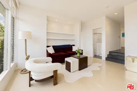 a living room with furniture and a lamp