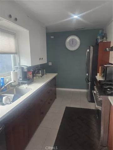 a kitchen with sink a stove and refrigerator