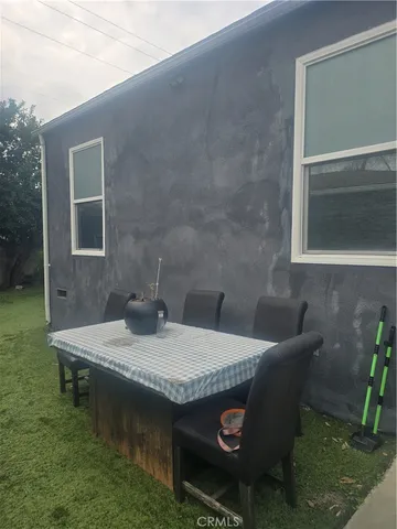 a view of a pathway of a house with a yard