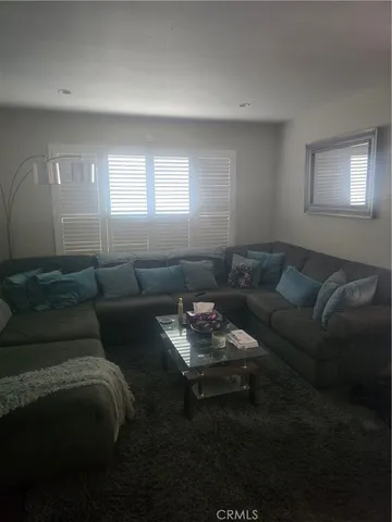 a living room with furniture and a hard wood floor