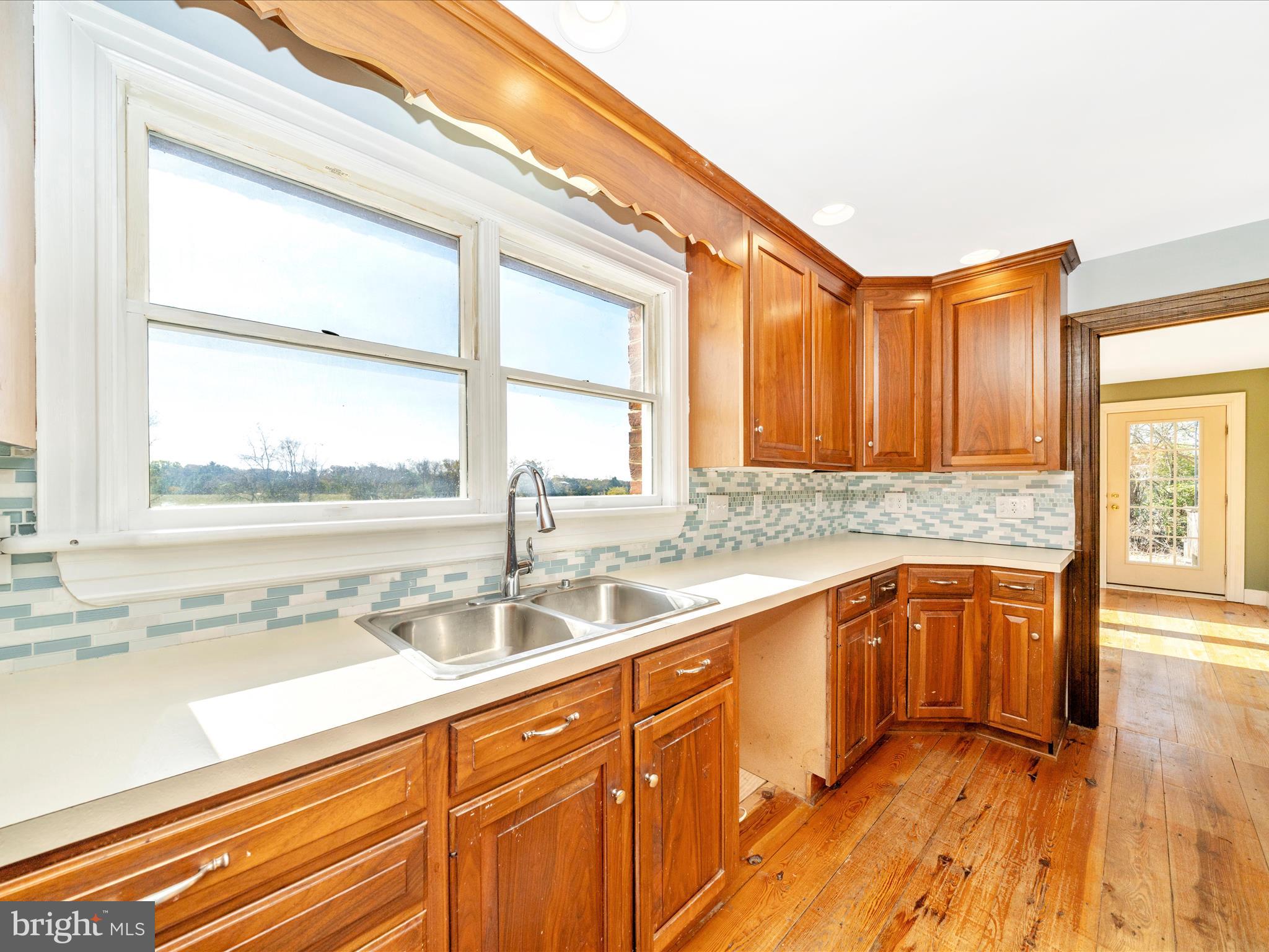 14924 Clear Spring Road Williamsport, MD 21795 - Photo 16 of 76 a kitchen with a sink a counter top space and a large window
