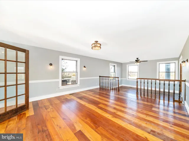 a view of an entryway with wooden floor and door