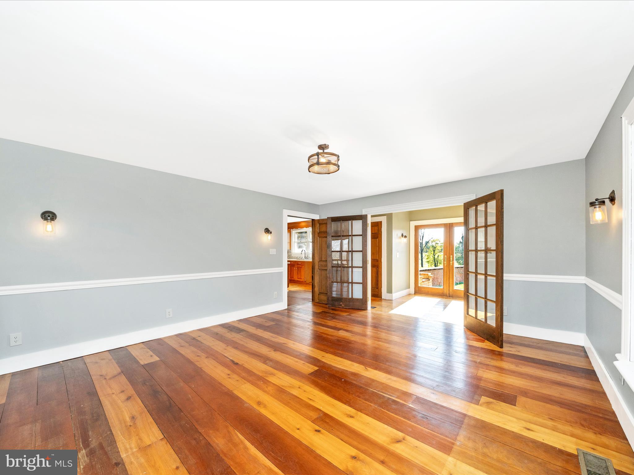 14924 Clear Spring Road Williamsport, MD 21795 - Photo 20 of 76 a view of an empty room with a window and wooden floor