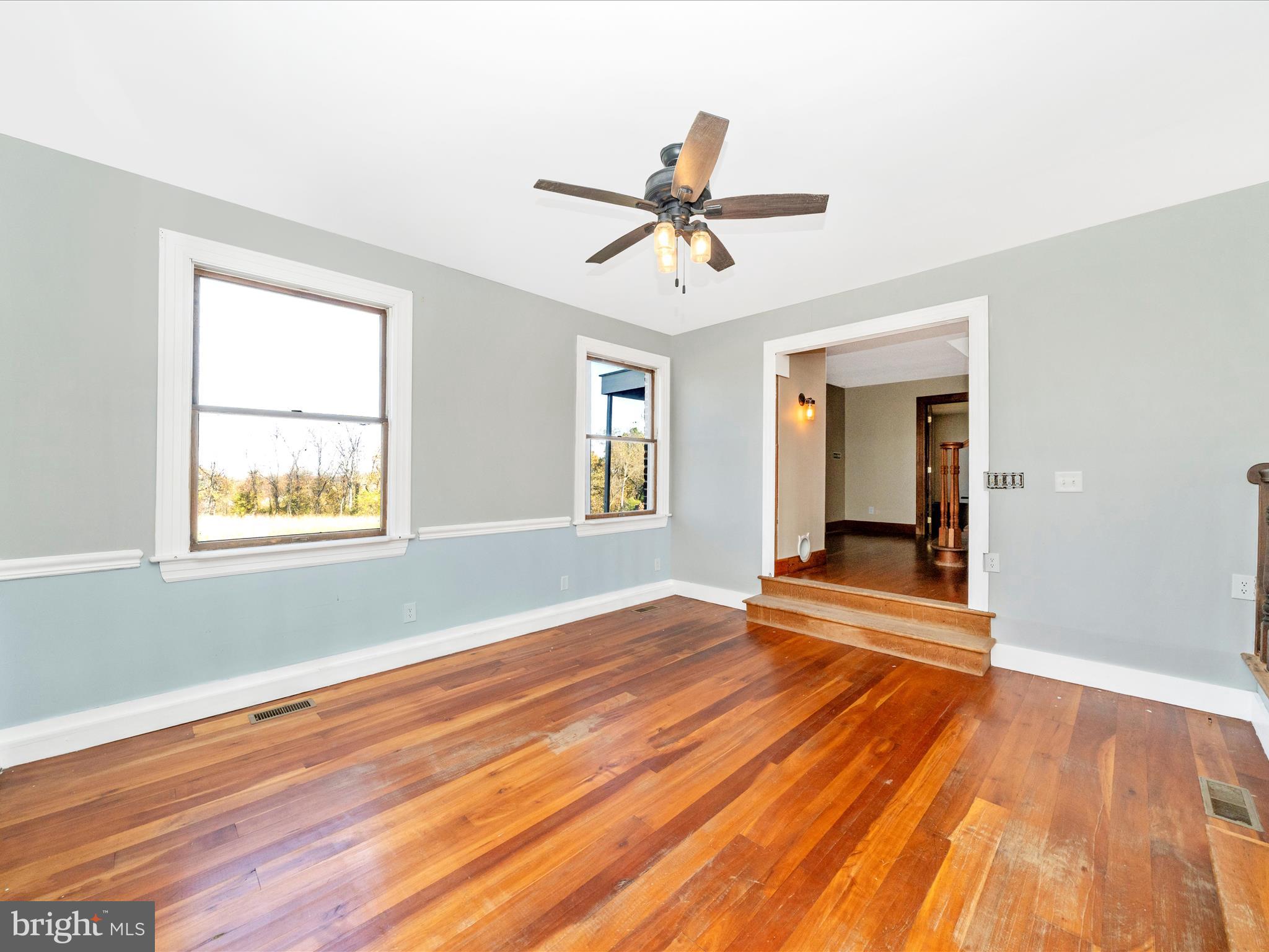 14924 Clear Spring Road Williamsport, MD 21795 - Photo 21 of 76 a view of empty room with wooden floor and fan