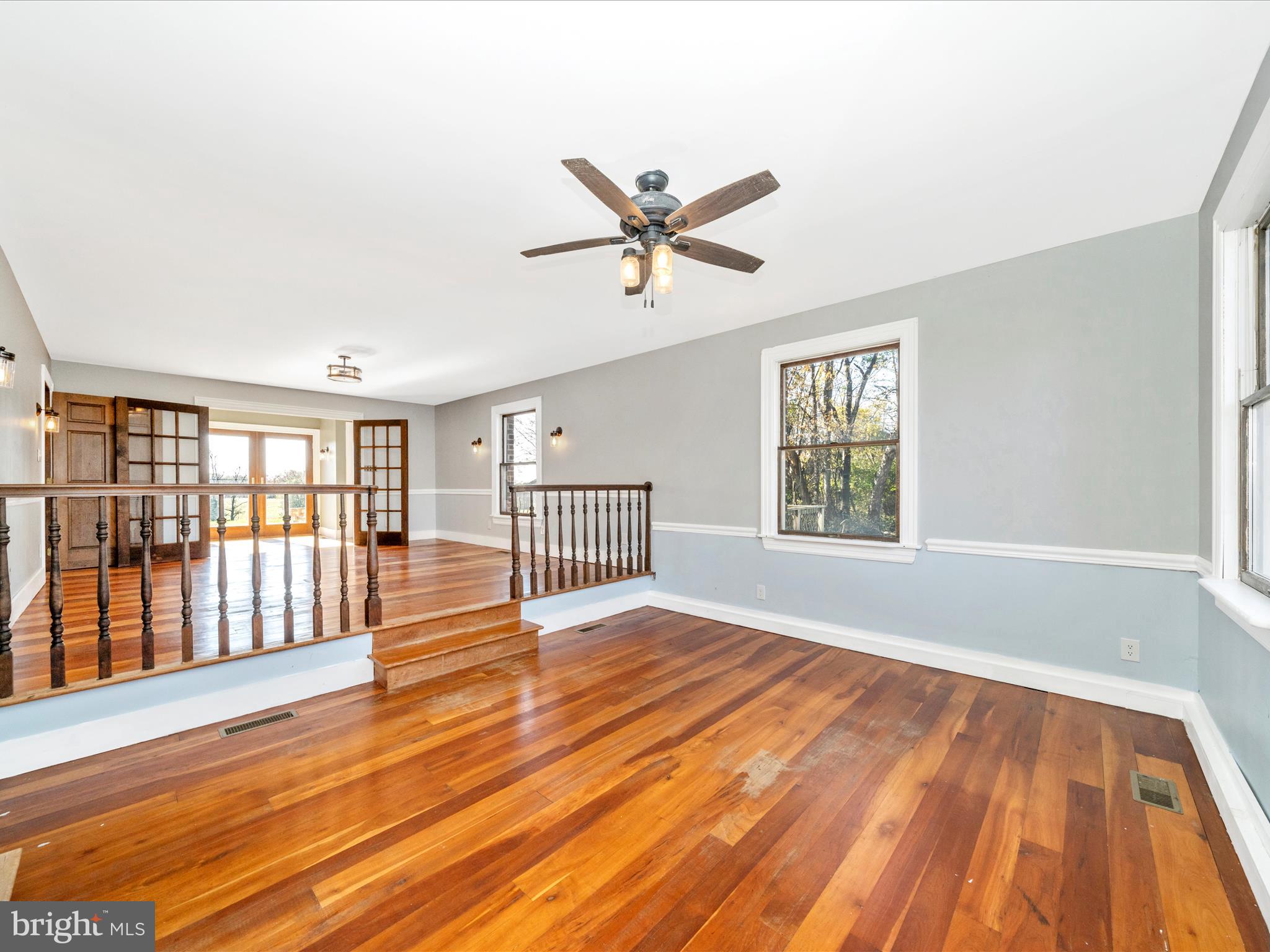 14924 Clear Spring Road Williamsport, MD 21795 - Photo 23 of 76 an empty room with wooden floor fan and windows