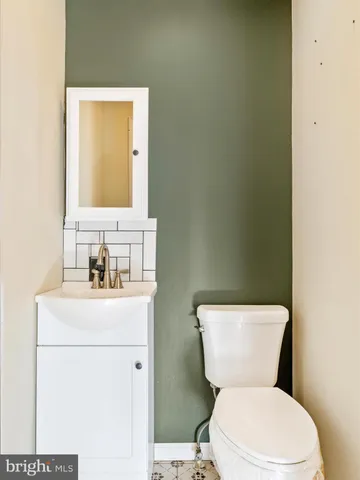 a white toilet sitting next to a shower