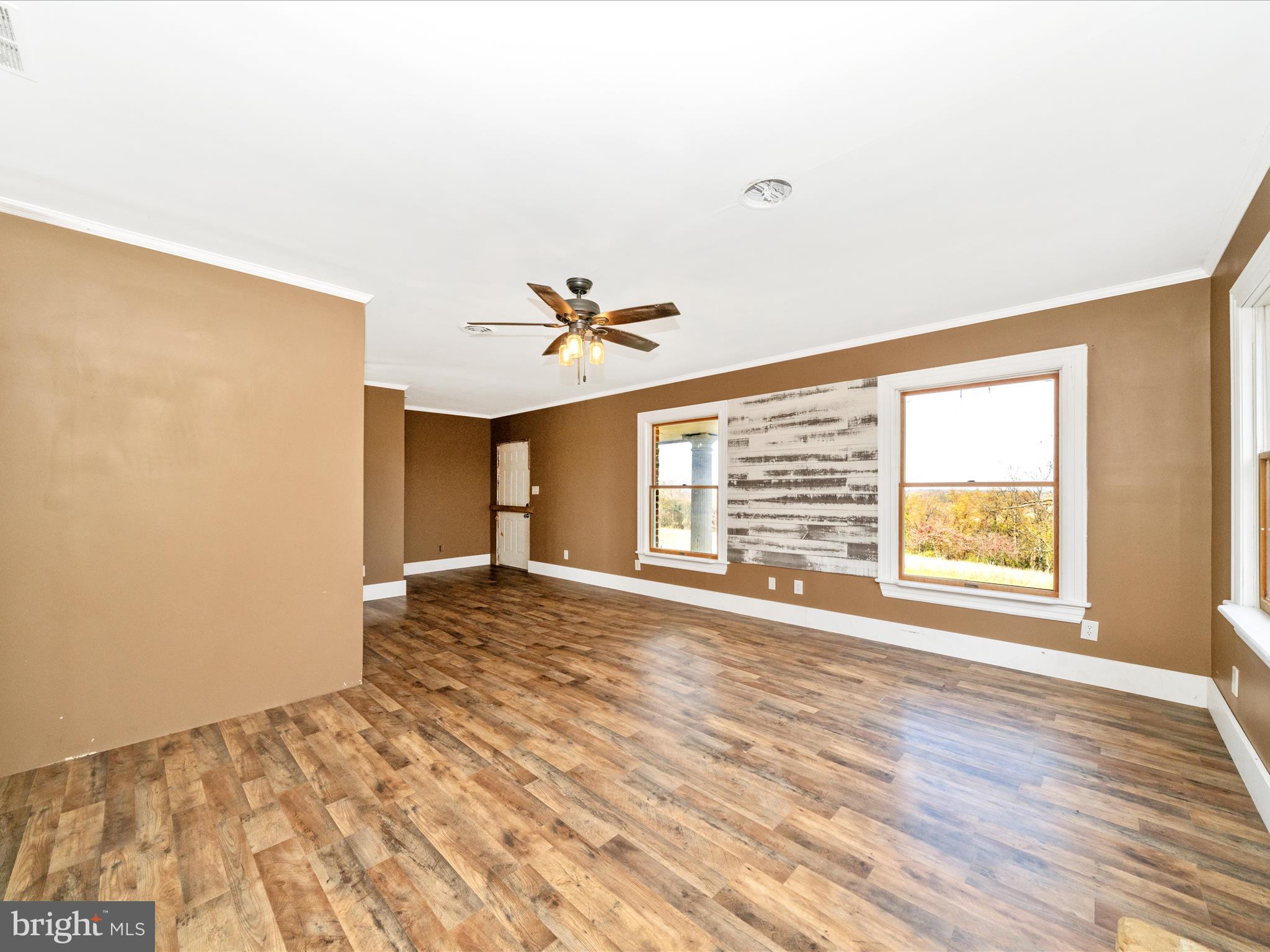 14924 Clear Spring Road Williamsport, MD 21795 - Photo 28 of 76 a view of an empty room with a window and wooden floor