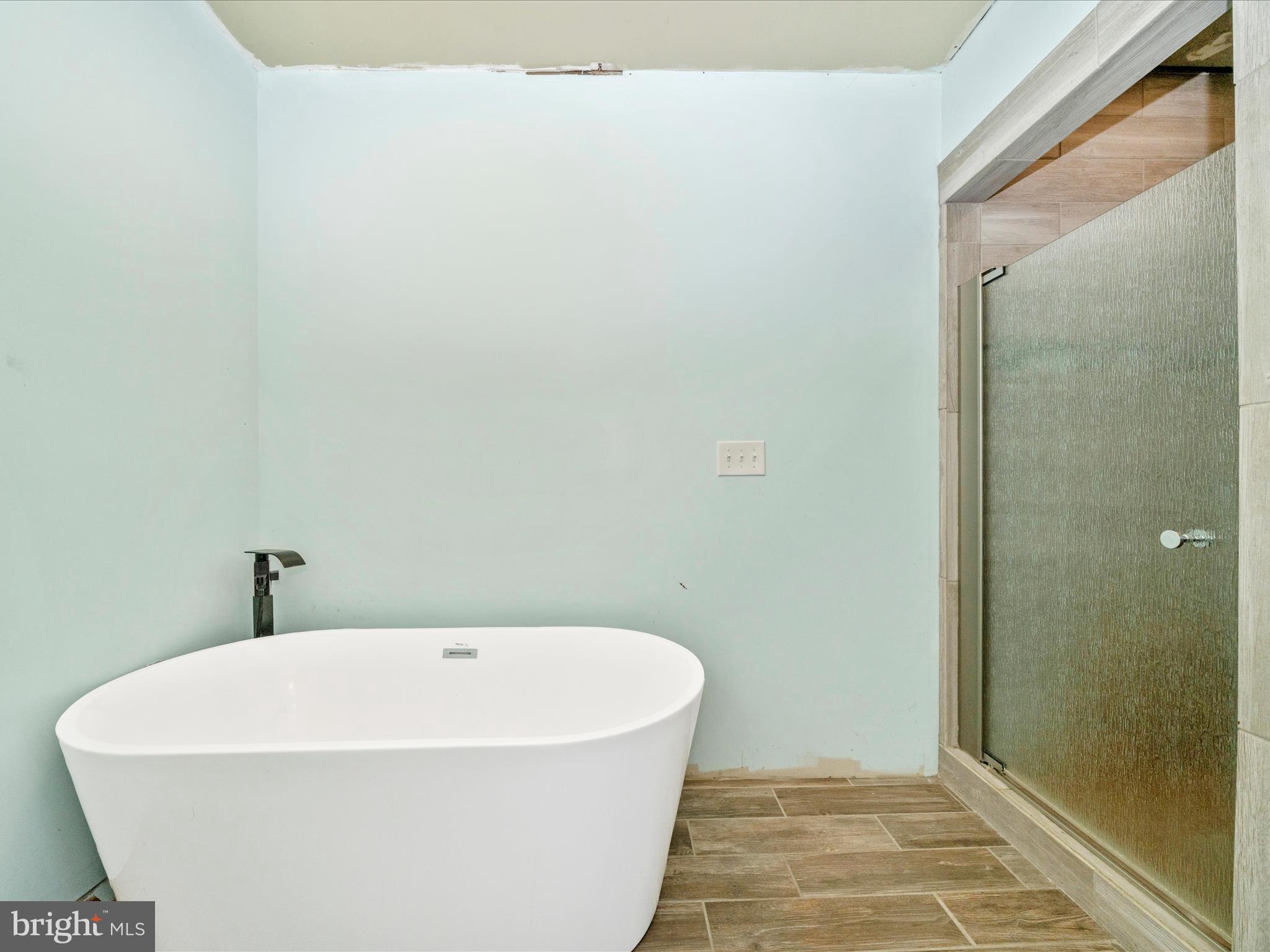 14924 Clear Spring Road Williamsport, MD 21795 - Photo 30 of 76 a white bath tub sitting in a bathroom