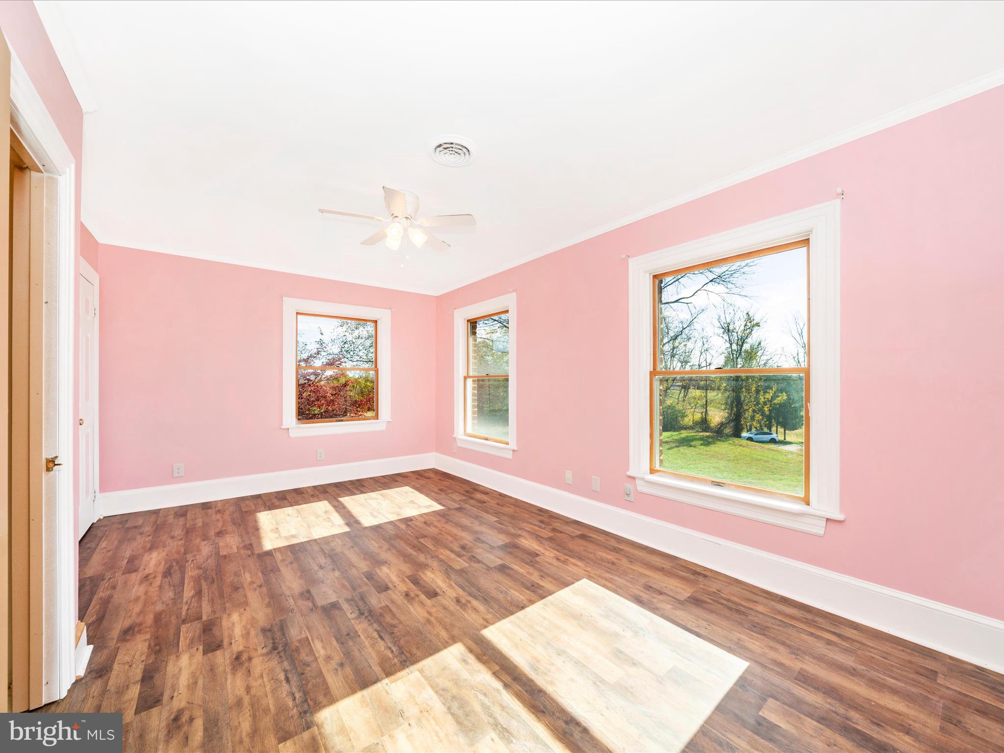 14924 Clear Spring Road Williamsport, MD 21795 - Photo 33 of 76 a view of an empty room with a window and wooden floor