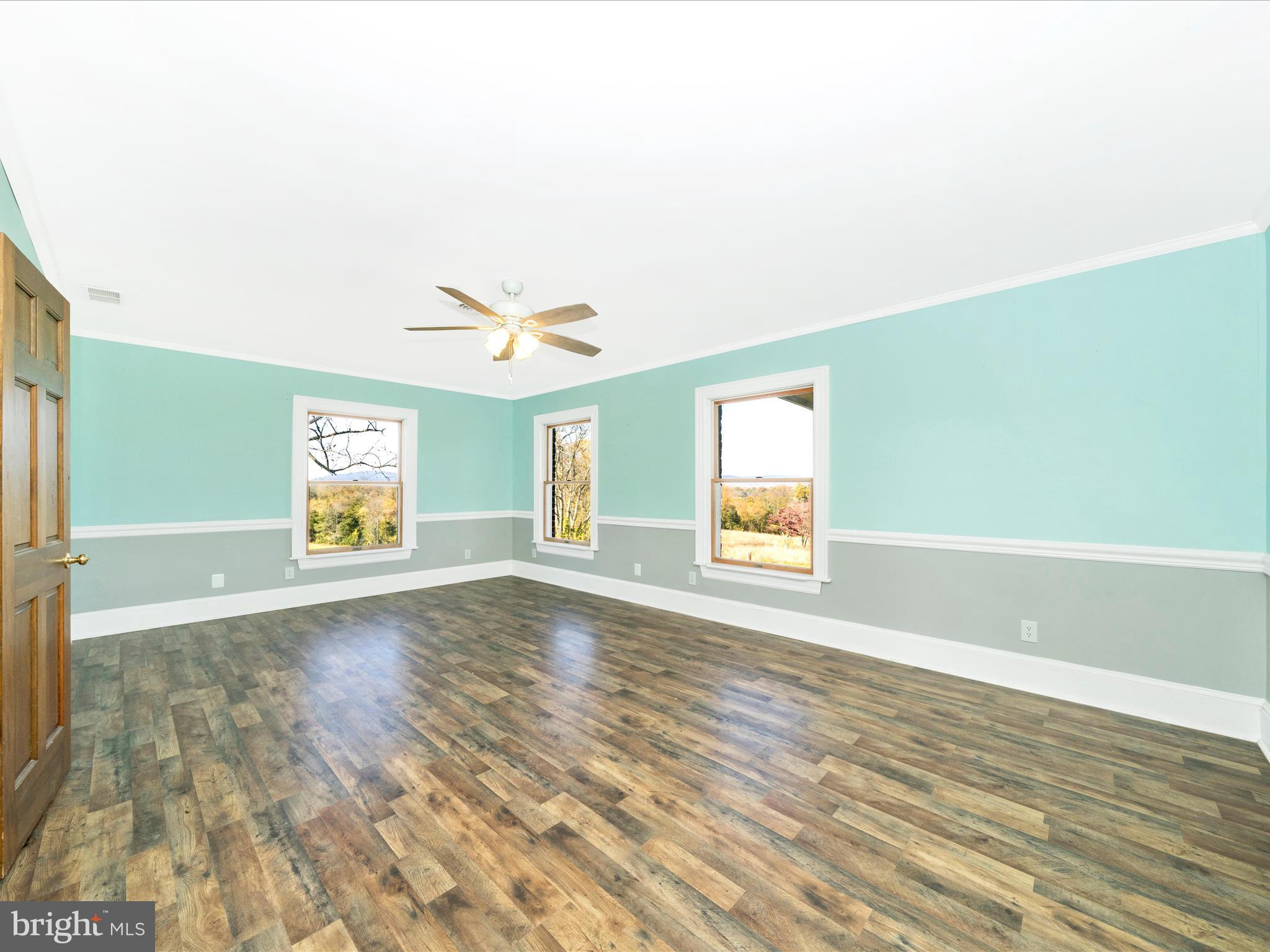 14924 Clear Spring Road Williamsport, MD 21795 - Photo 38 of 76 an empty room with wooden floor and windows