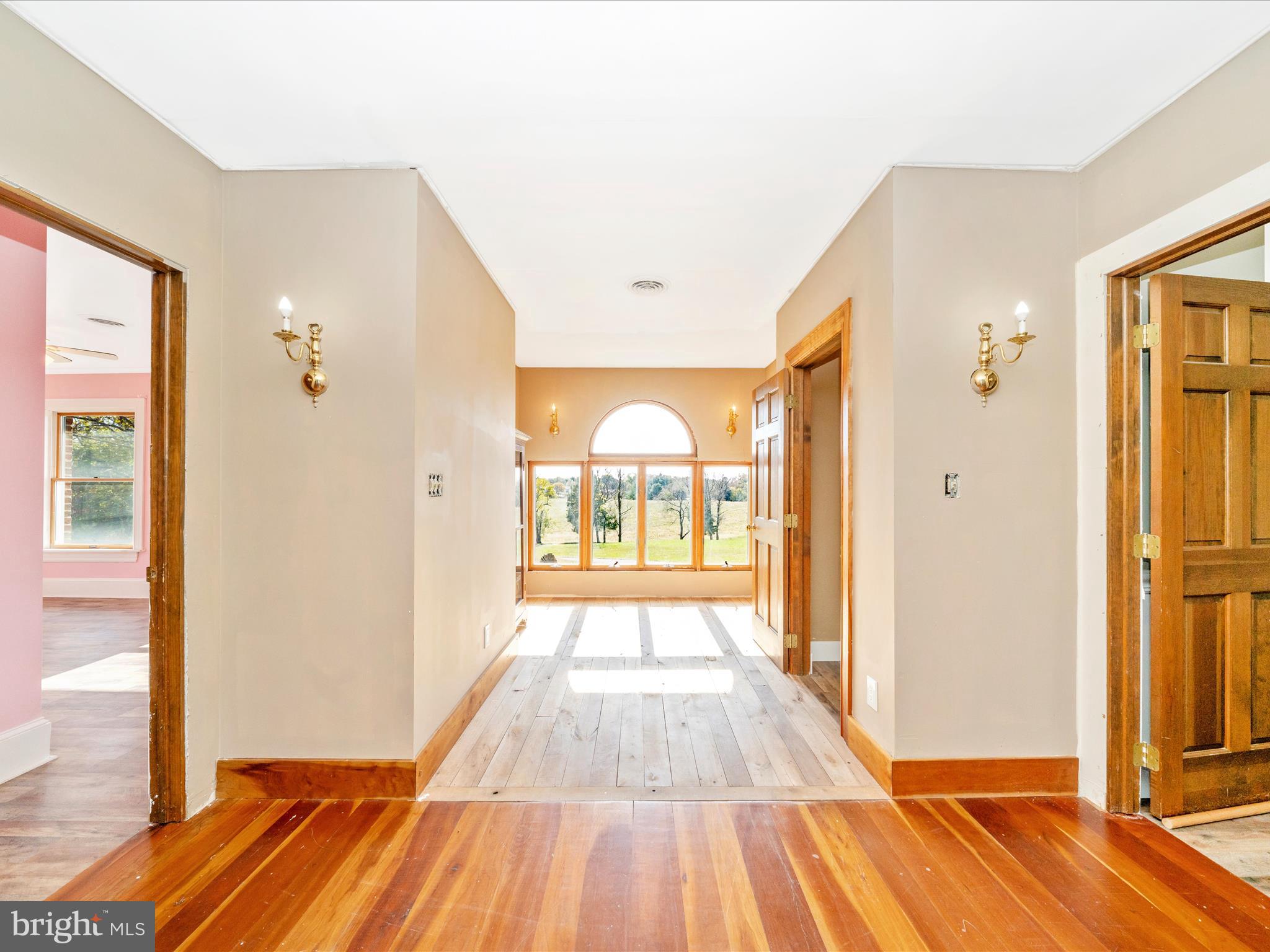14924 Clear Spring Road Williamsport, MD 21795 - Photo 42 of 76 a view of a hallway with wooden floor and a bathroom