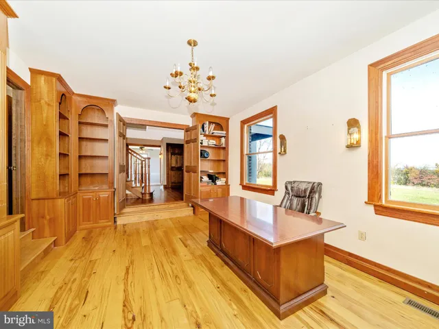 a view of a dining room with furniture and a chandelier