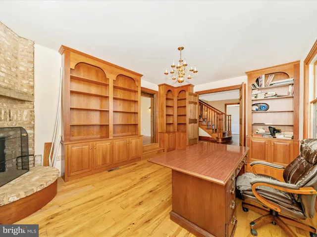 a spacious bedroom with a bed and wooden floor