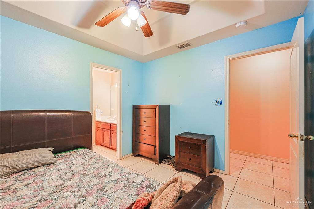 713 West 24th Place Mission, TX 78574 - Photo 22 of 36 a bedroom with a bed and a television