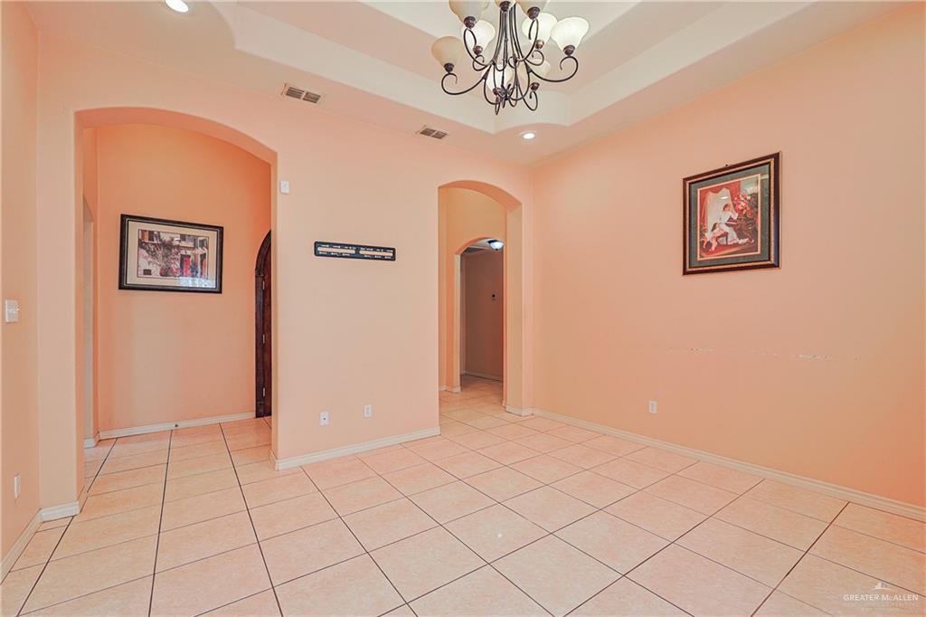 713 West 24th Place Mission, TX 78574 - Photo 7 of 36 a view of a livingroom with a chandelier fan and windows