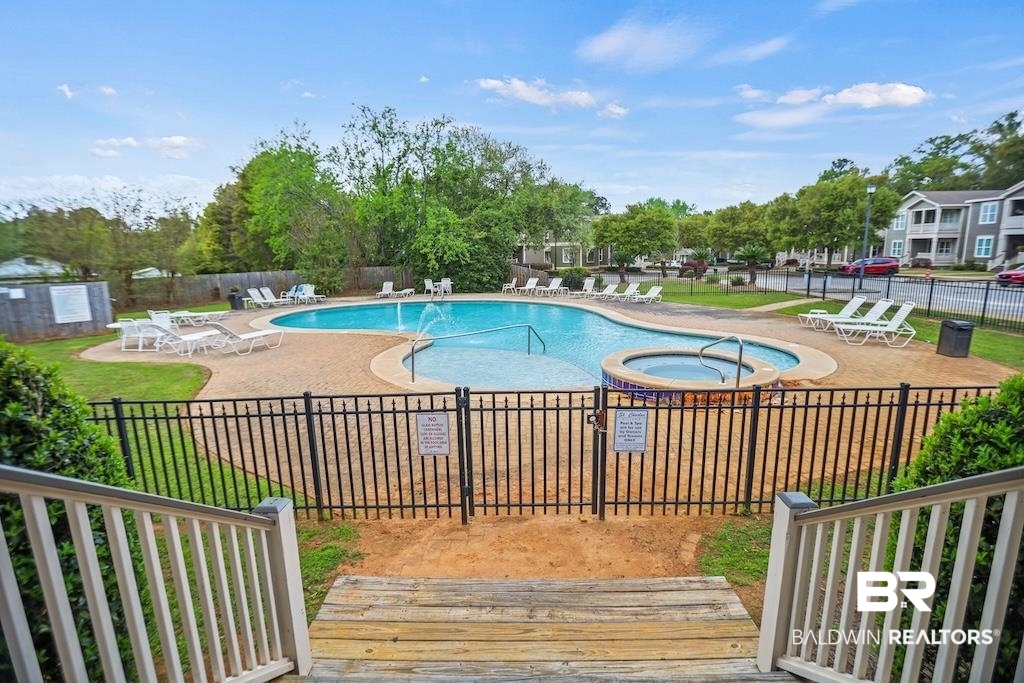 25806 Pollard Road, Unit 27 Daphne, AL 36526 - Photo 45 of 46 Community pool with a patio and a hot tub