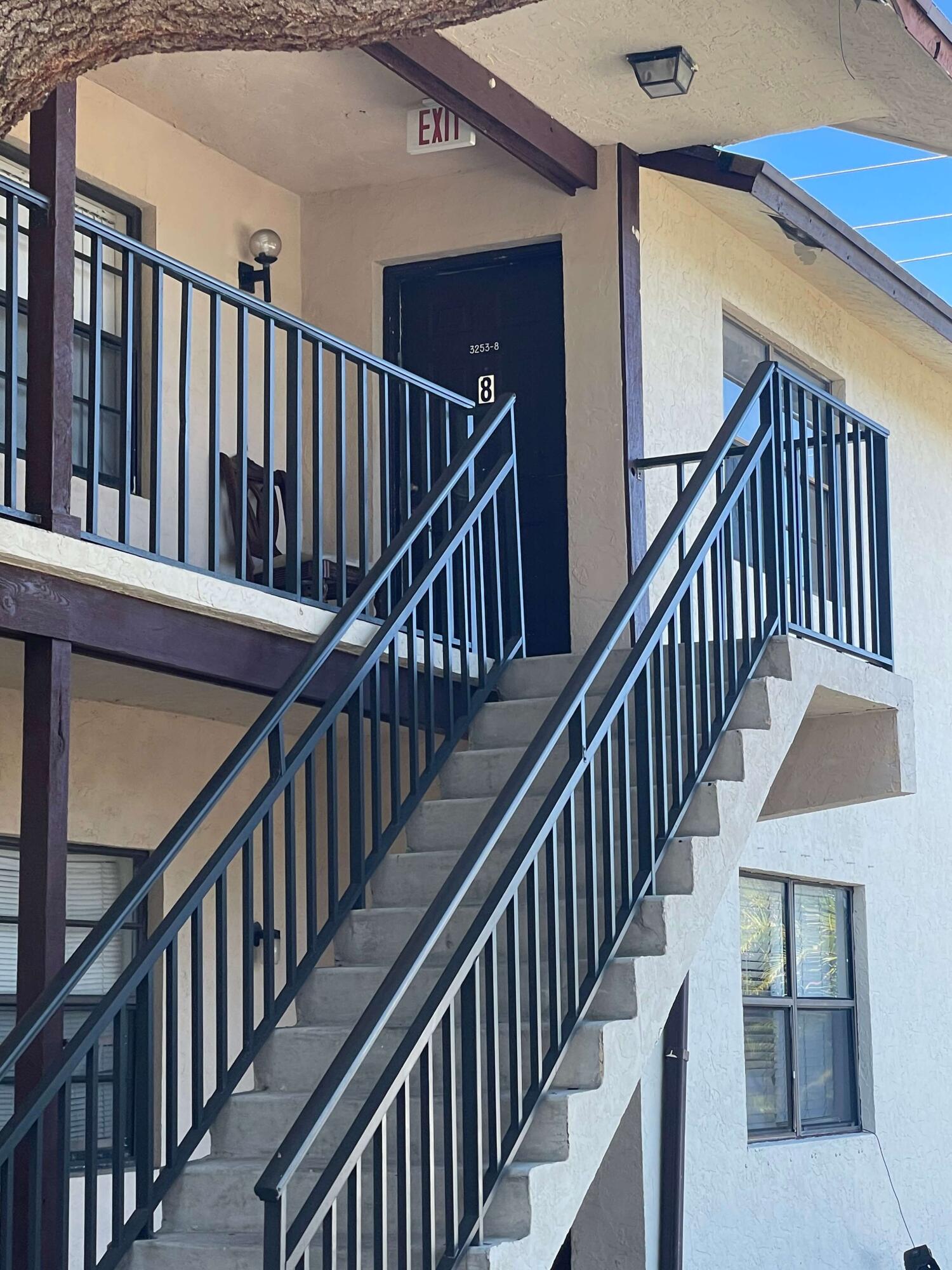 3253 Kirk Road, Unit 8 Lake Worth, FL 33461 - Photo 2 of 8 a view of staircase with railing and white walls