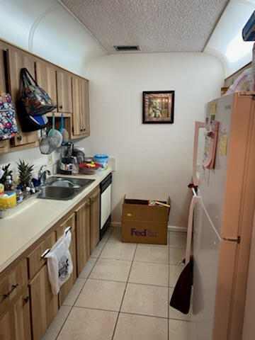 3253 Kirk Road, Unit 8 Lake Worth, FL 33461 - Photo 3 of 8 a kitchen with a refrigerator and a sink