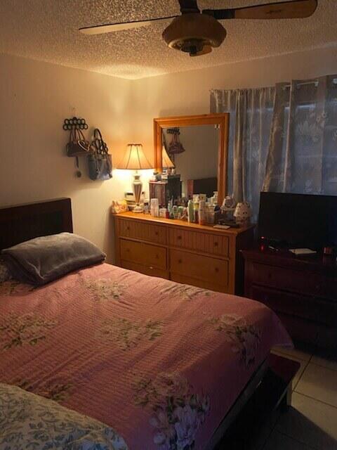 3253 Kirk Road, Unit 8 Lake Worth, FL 33461 - Photo 7 of 8 a bedroom with a bed and cabinets