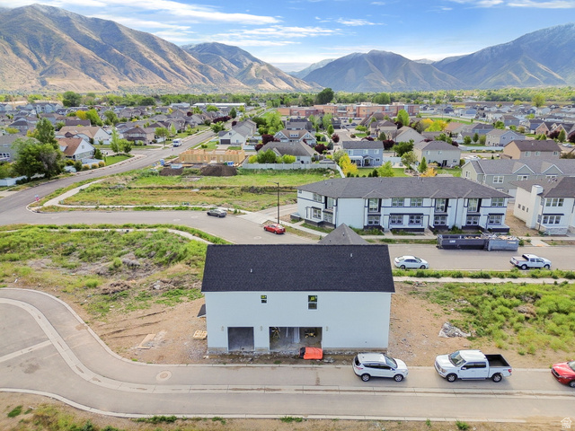 720 South Harrison Drive Springville, UT 84663 - Photo 7 of 14 Newly constructed residence featuring a white exterior, dark shingle roof, and a two-car garage