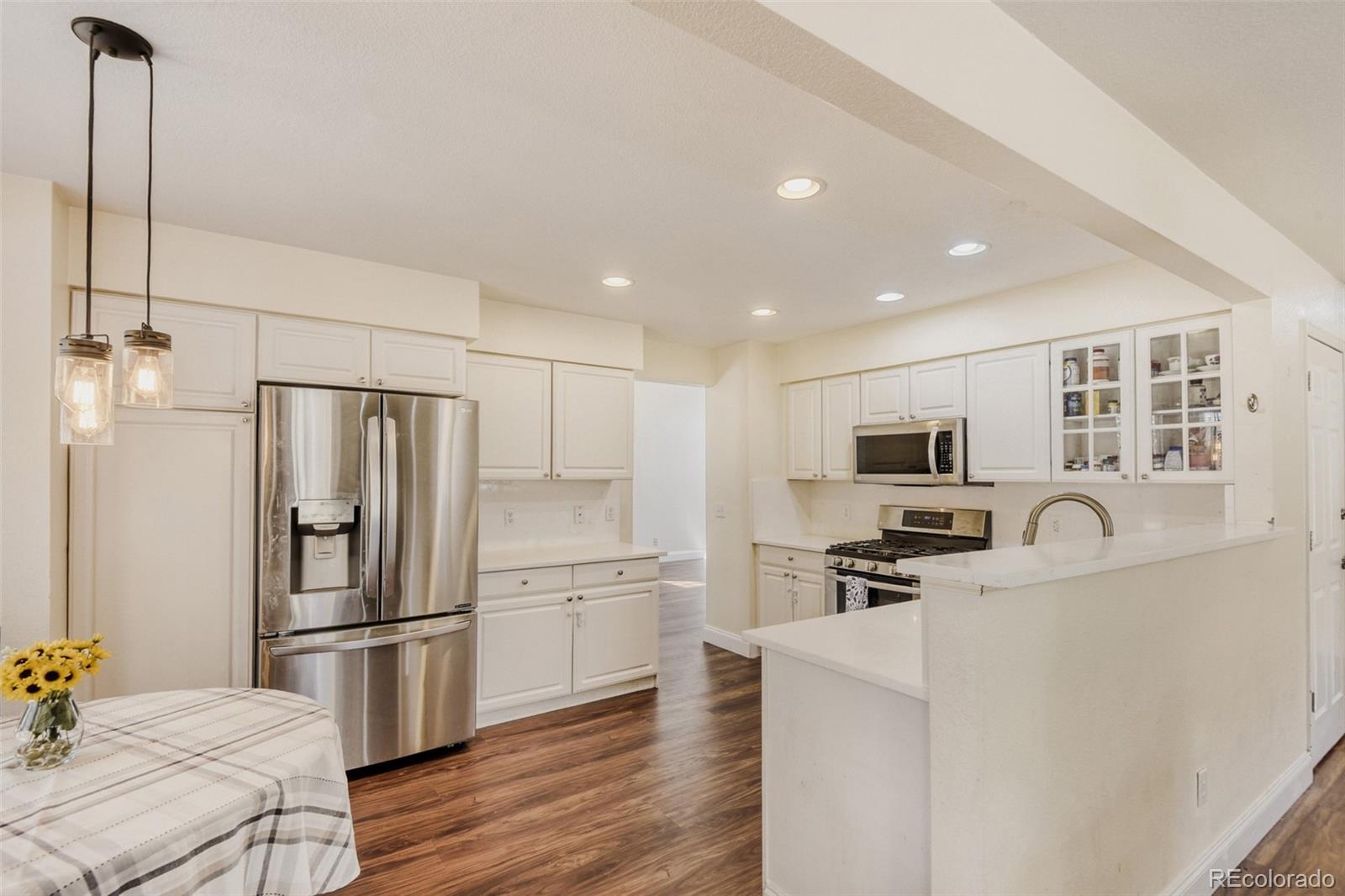 10047 Andrush Court Lone Tree, CO 80124 - Photo 11 of 37 a kitchen with stainless steel appliances a refrigerator stove microwave and sink