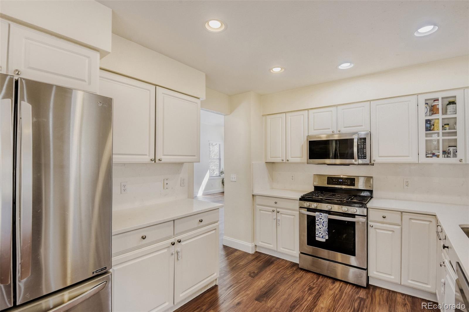 10047 Andrush Court Lone Tree, CO 80124 - Photo 12 of 37 a kitchen with stainless steel appliances white cabinets and a refrigerator