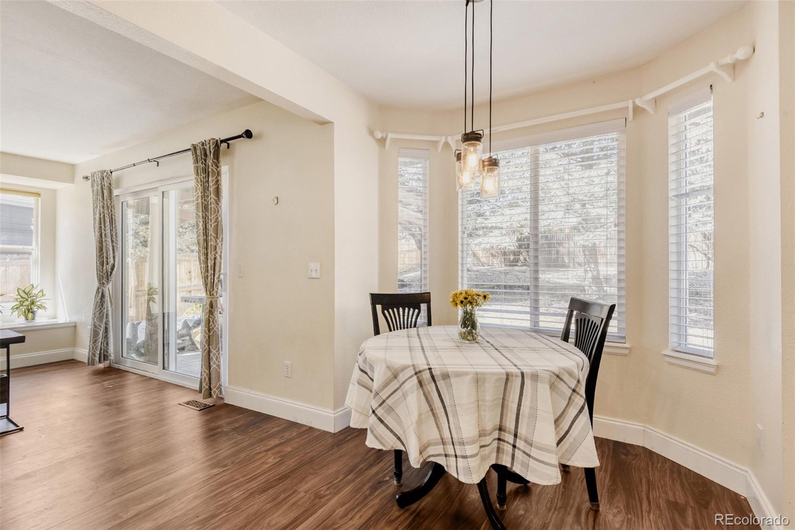 10047 Andrush Court Lone Tree, CO 80124 - Photo 15 of 37 a view of a dining room with furniture window and wooden floor