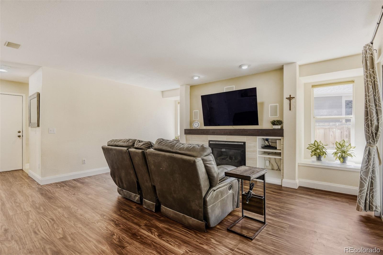 10047 Andrush Court Lone Tree, CO 80124 - Photo 17 of 37 a living room with furniture and a flat screen tv