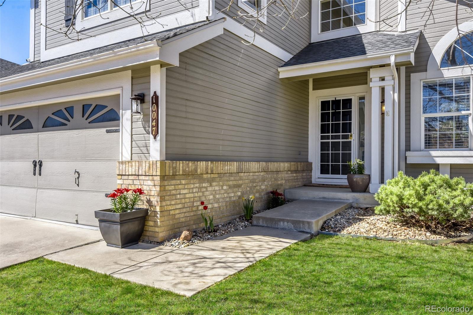 10047 Andrush Court Lone Tree, CO 80124 - Photo 2 of 37 a view of a house with a yard and plants