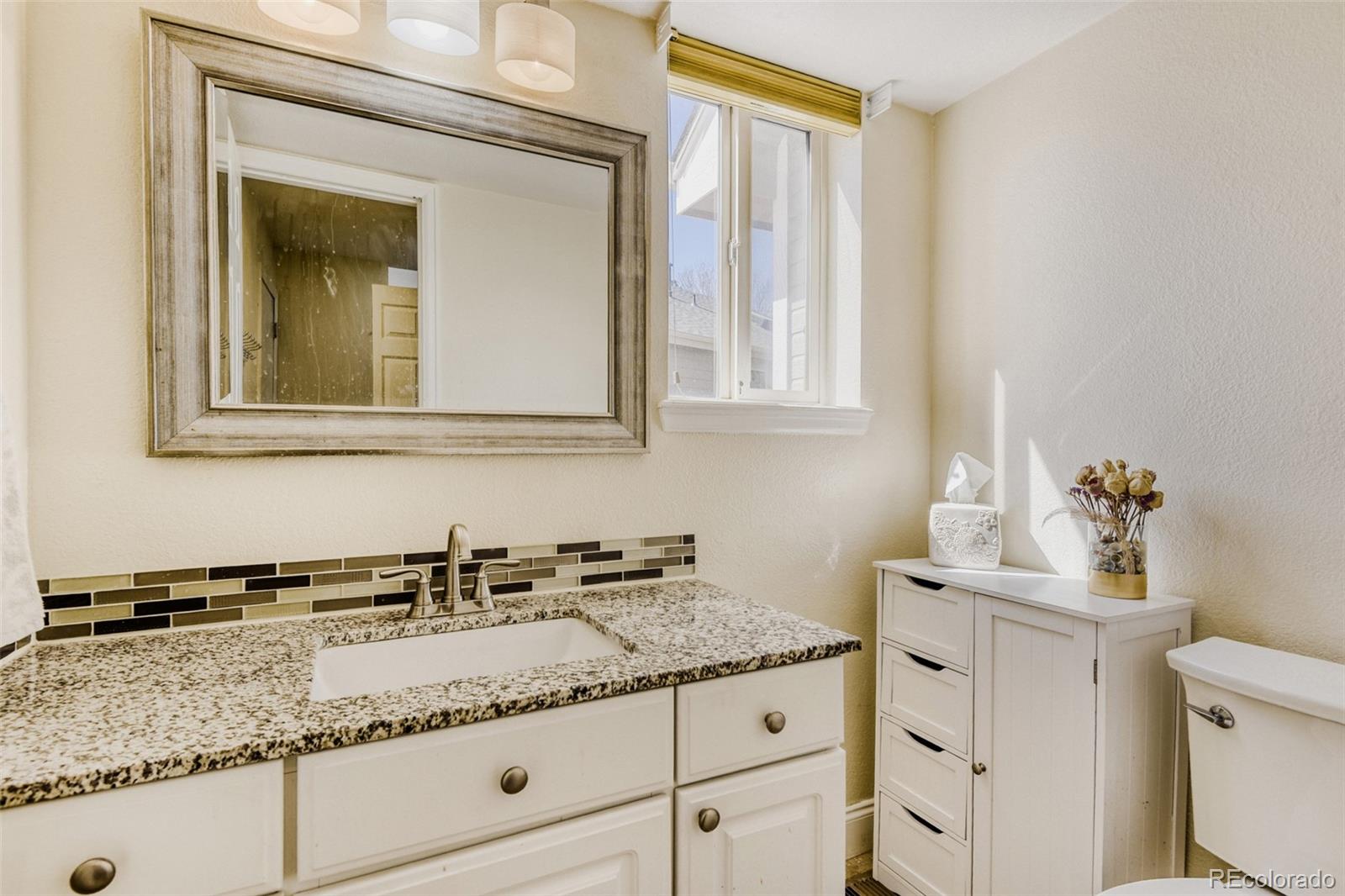 10047 Andrush Court Lone Tree, CO 80124 - Photo 21 of 37 a bathroom with a sink and a vanity