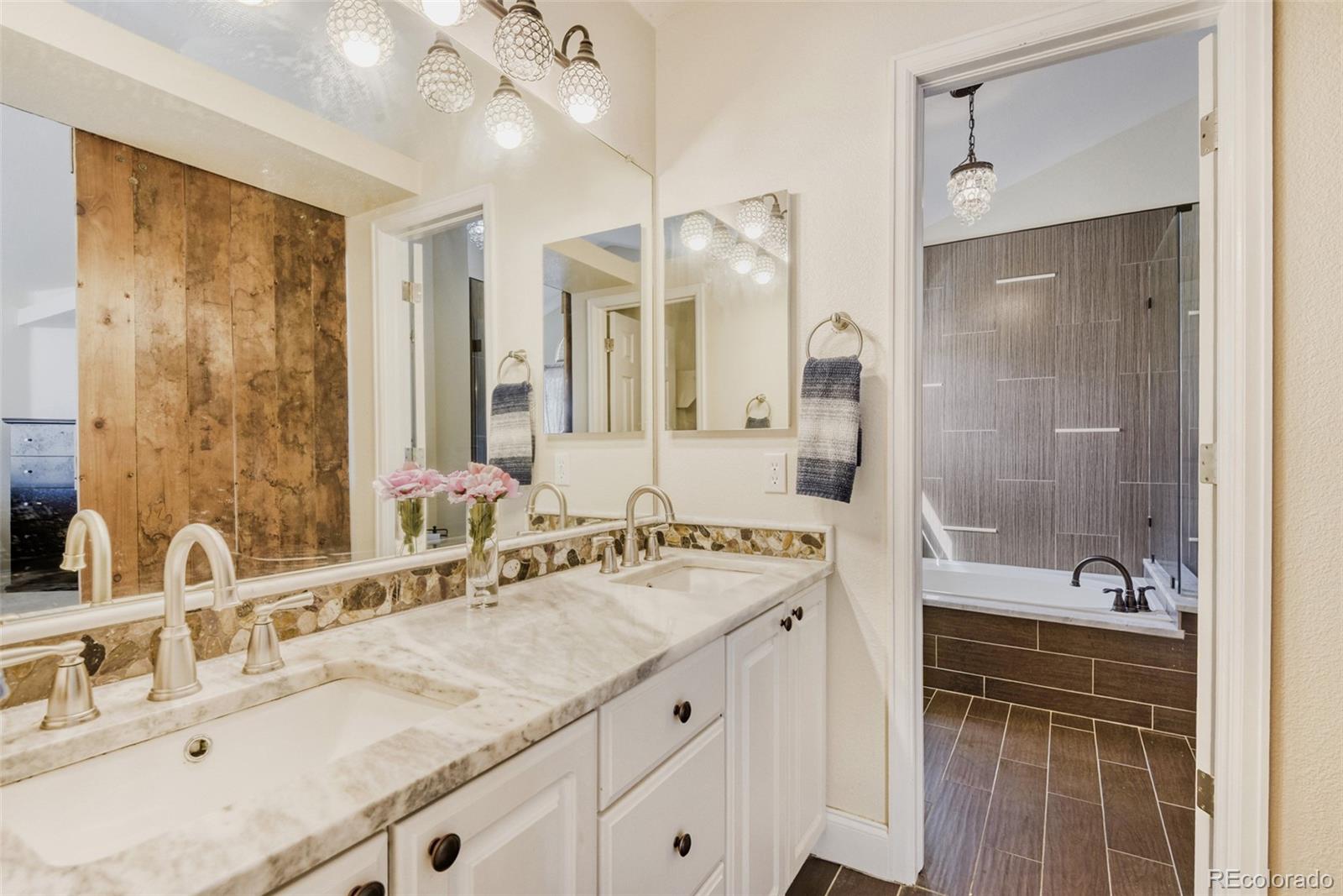 10047 Andrush Court Lone Tree, CO 80124 - Photo 24 of 37 a bathroom with a granite countertop sink mirror and double