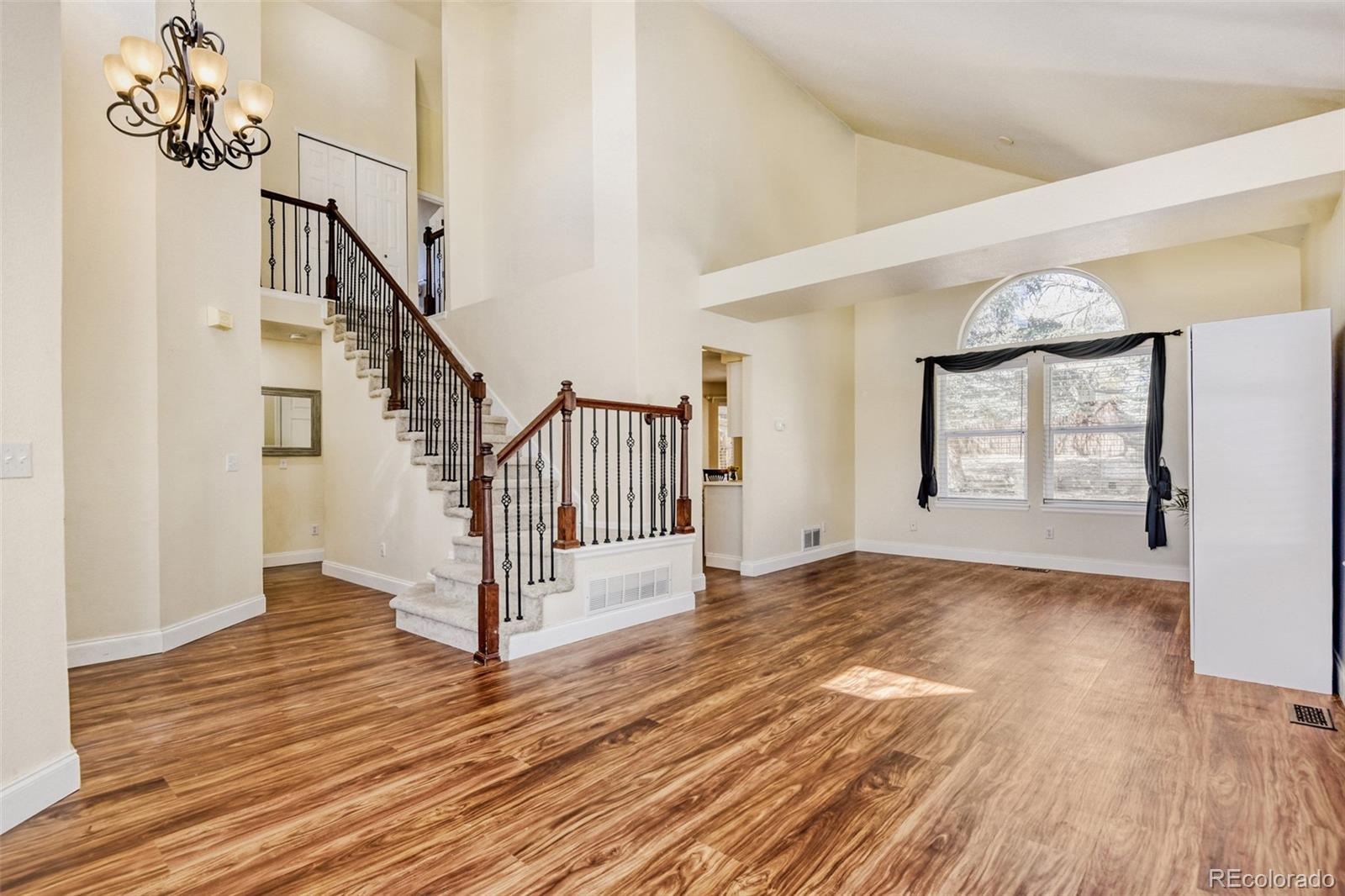 10047 Andrush Court Lone Tree, CO 80124 - Photo 4 of 37 a view of an entryway with wooden floor and stairs