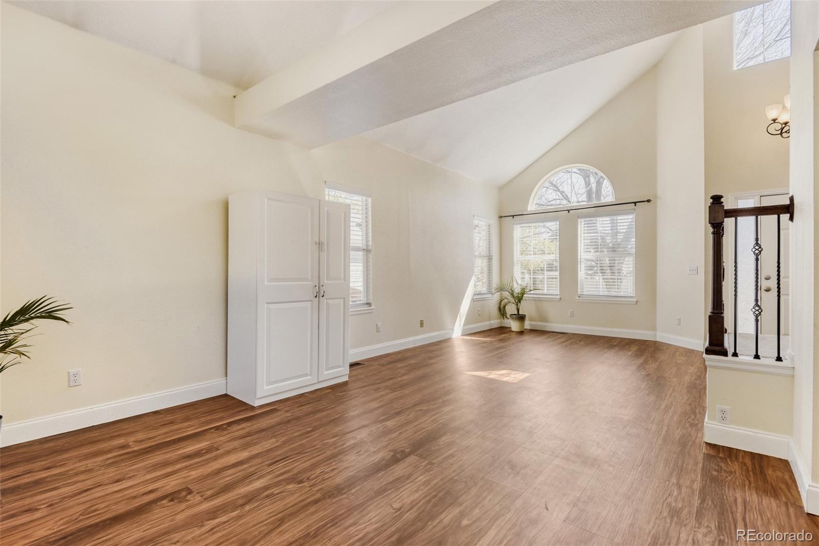 10047 Andrush Court Lone Tree, CO 80124 - Photo 8 of 37 an empty room with wooden floor and windows