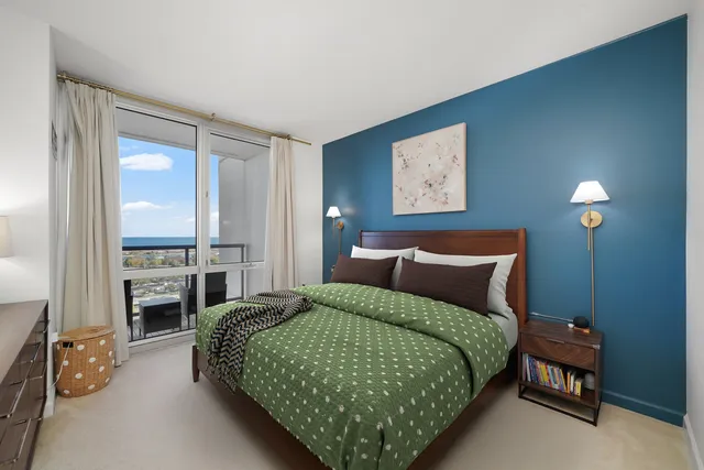 a bedroom with a bed and painting on the wall