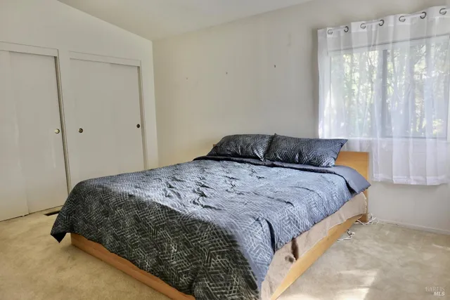 a bedroom with a bed and window