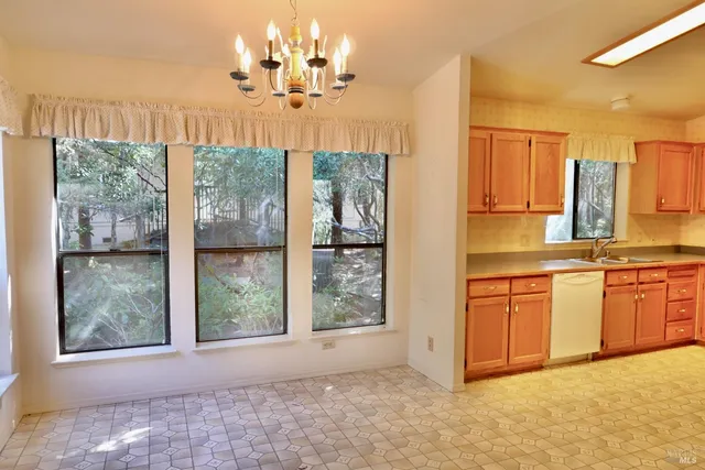 a view of a kitchen with granite countertop a sink and cabinets