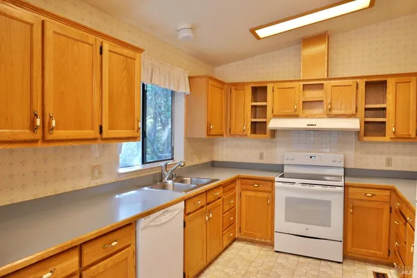 a kitchen with a sink stove and cabinets