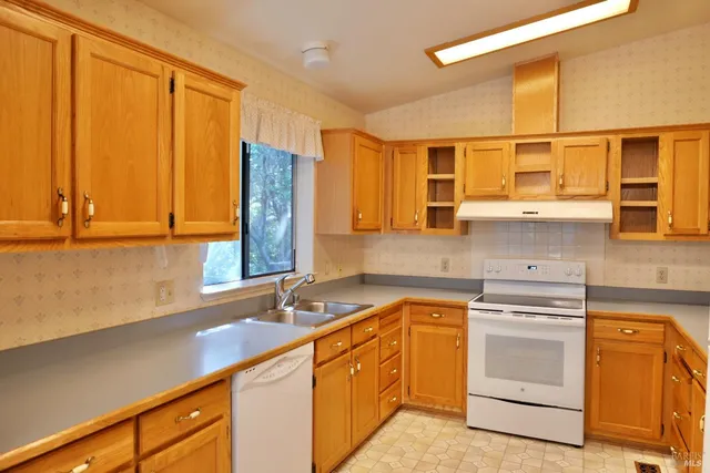 a kitchen with a sink stove and cabinets