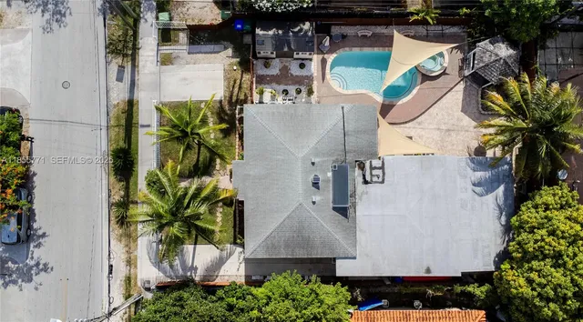 an aerial view of a swimming pool with outdoor seating and plants
