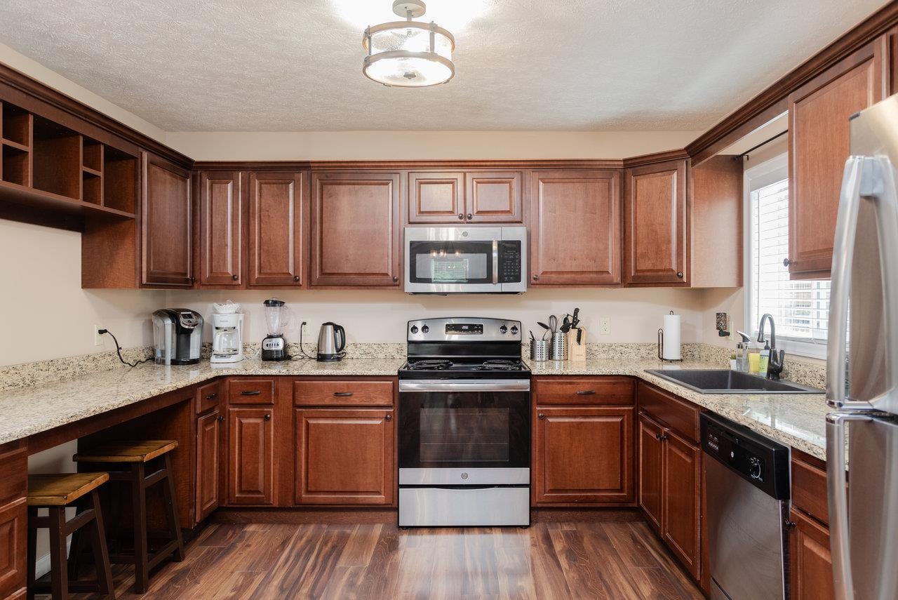 159 Park View Shenandoah, VA 22849 - Photo 12 of 70 a kitchen with stainless steel appliances granite countertop wooden cabinets a sink a stove a refrigerator and cabinets
