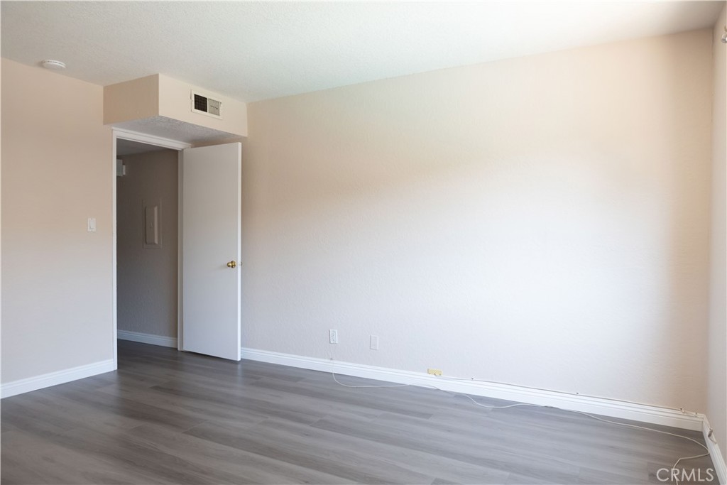 2386 East Del Mar Boulevard, Unit 203 Pasadena, CA 91107 - Photo 13 of 28 a view of an empty room with wooden floor